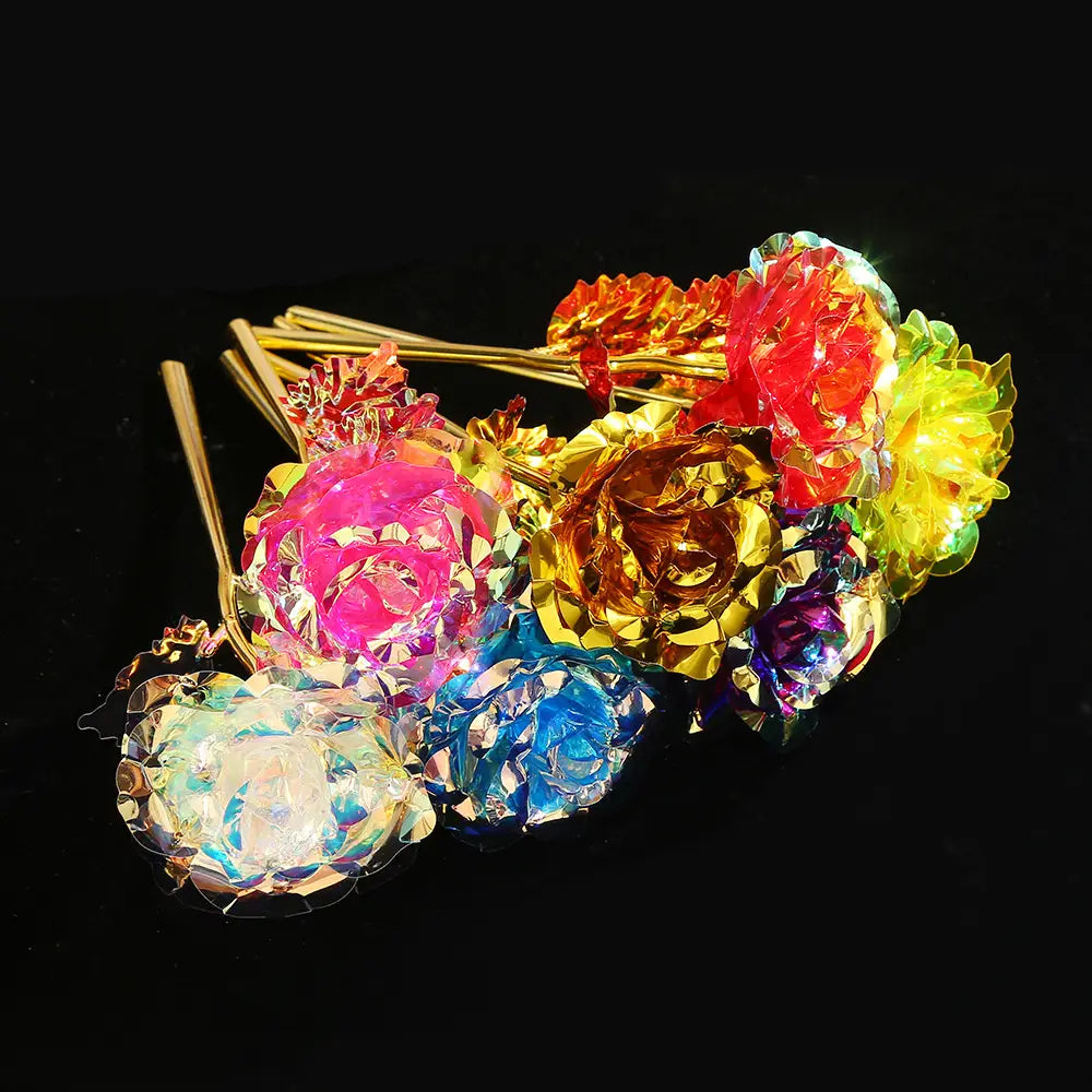 A collection of gold foil artificial rose eternal gift flowers in vibrant iridescent pink, gold, red, blue, and green decorative pick colors.