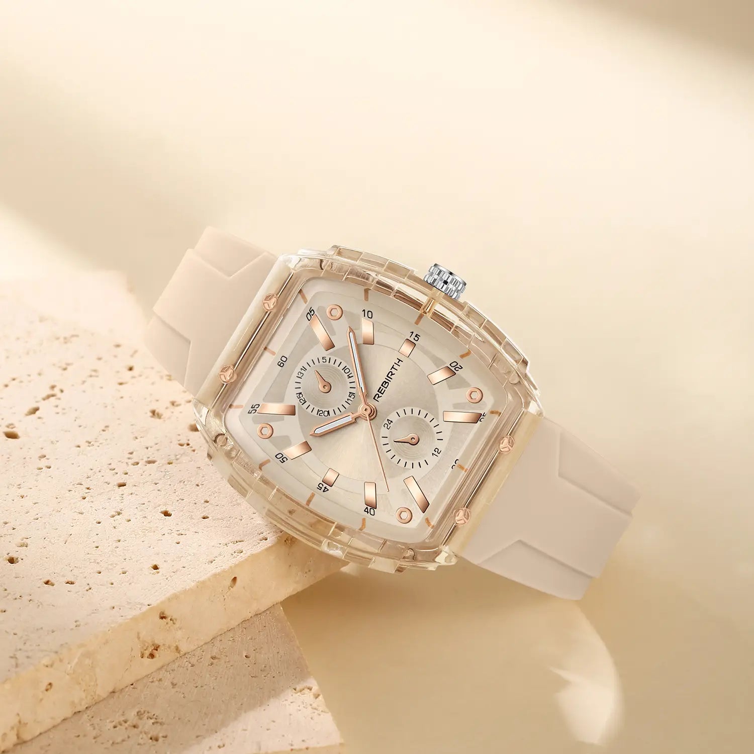A silicone casual watch with a sleek transparent case and rose gold accents frames a white dial and matching silicone strap in a modern rectangular design.