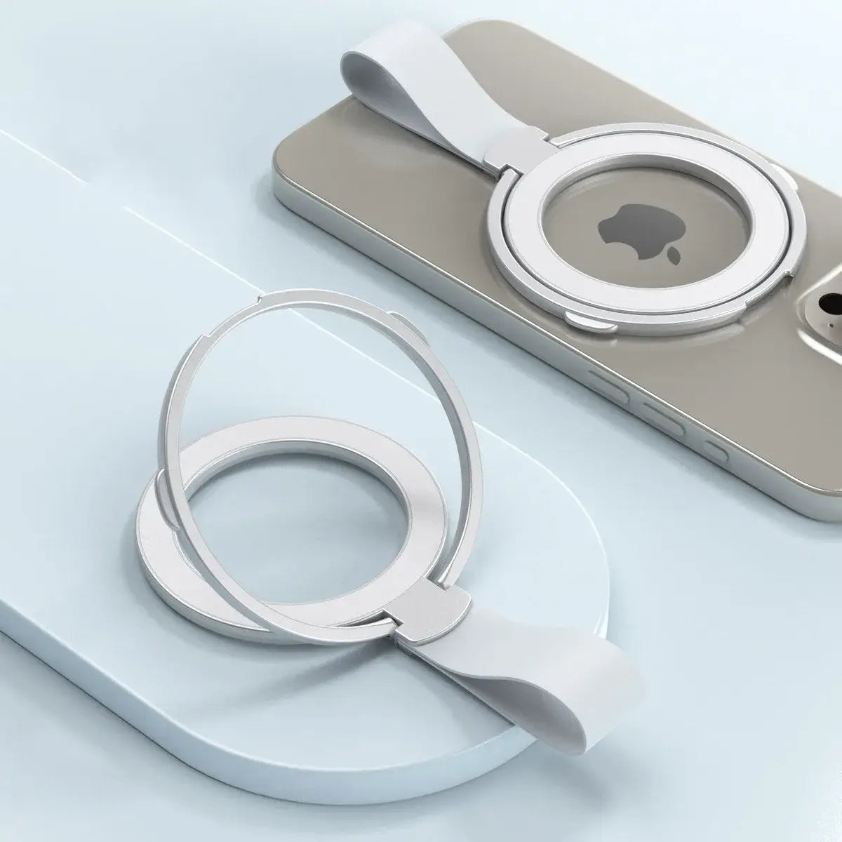 Silver magnetic phone ring holder with a sleek minimalist design and soft white silicone strap shown from the back side for Magsafe compatibility.