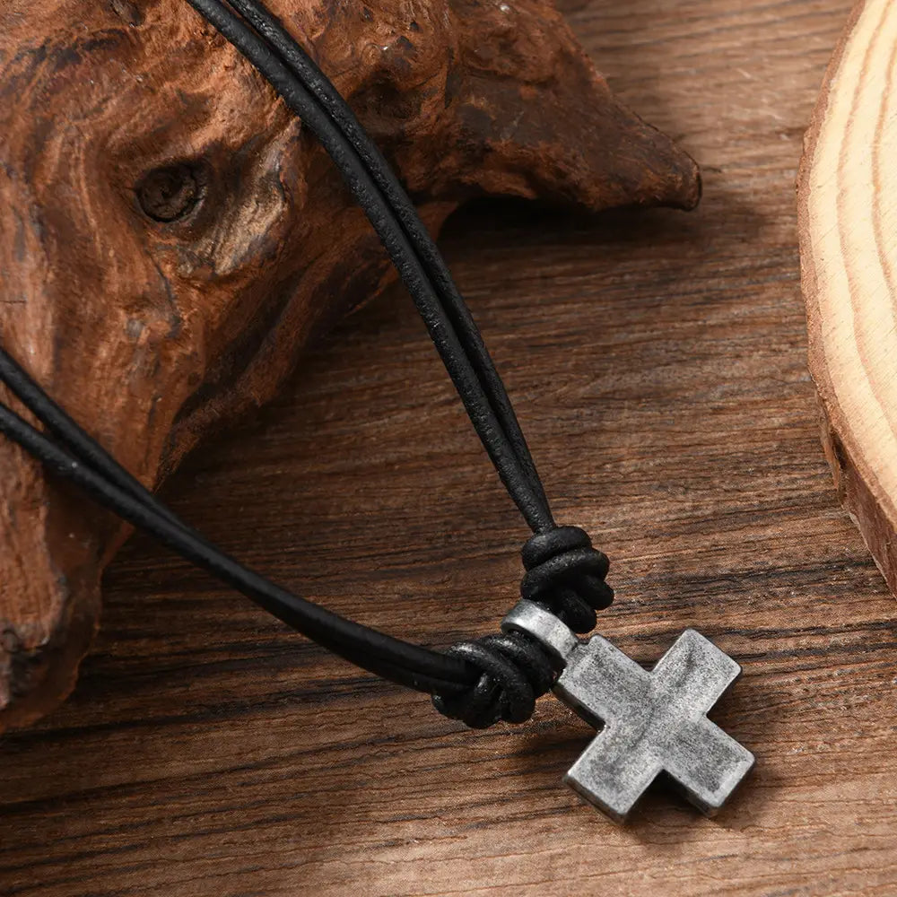 black leather cord necklace with a silver-toned matte-finished cross pendant made of material alloy