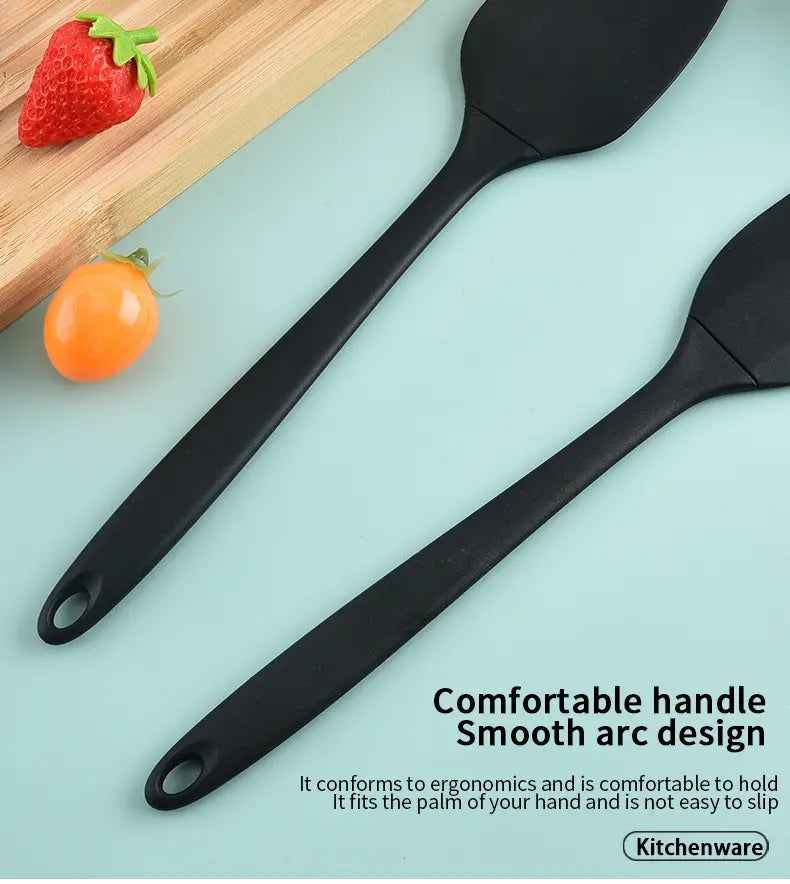 Black silicone kitchenware set featuring spatulas with smooth ergonomic handles and a sleek modern design for baking and cooking.