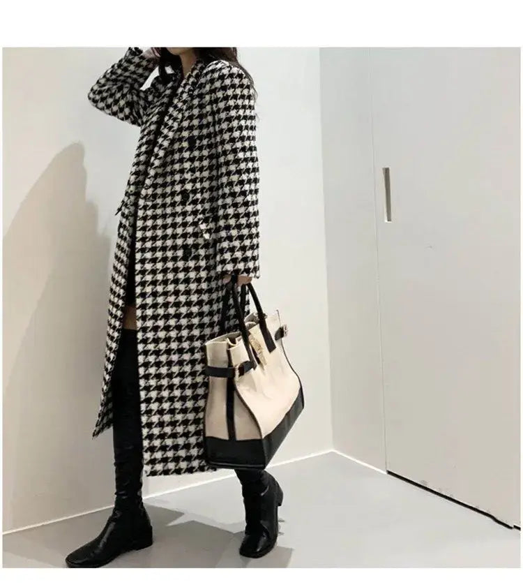 A stylish black and white houndstooth wool double breasted coat with a classic long design.
