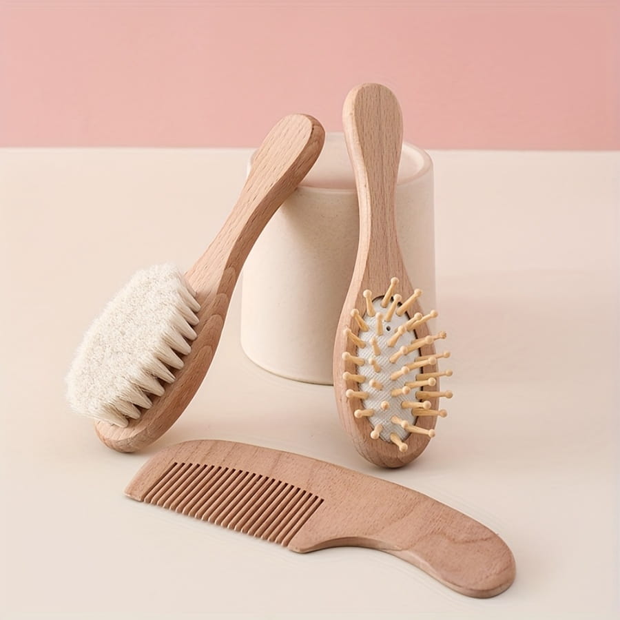 Baby wooden grooming set and healthcare kit featuring a set of three natural wood hairbrushes and comb with soft bristles and one plush white brush head.