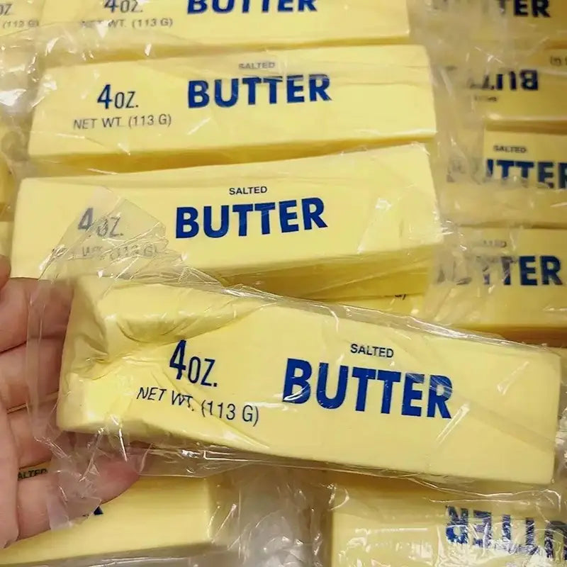 slow rising butter stick stress relief toy featuring yellow salted butter sticks individually wrapped in clear plastic with blue butter labeling.
