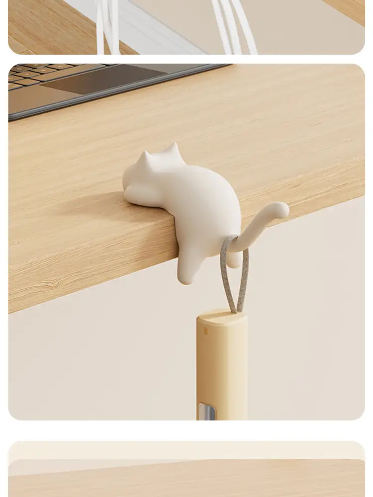 White ceramic cat-shaped desk hook silicone organizer with a looped cord for hanging items.