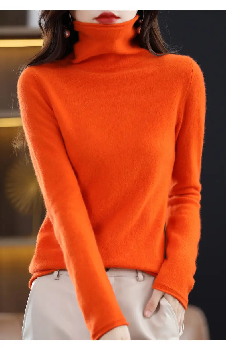 Vibrant orange merino wool turtleneck sweater for women featuring a high neck and long sleeves.