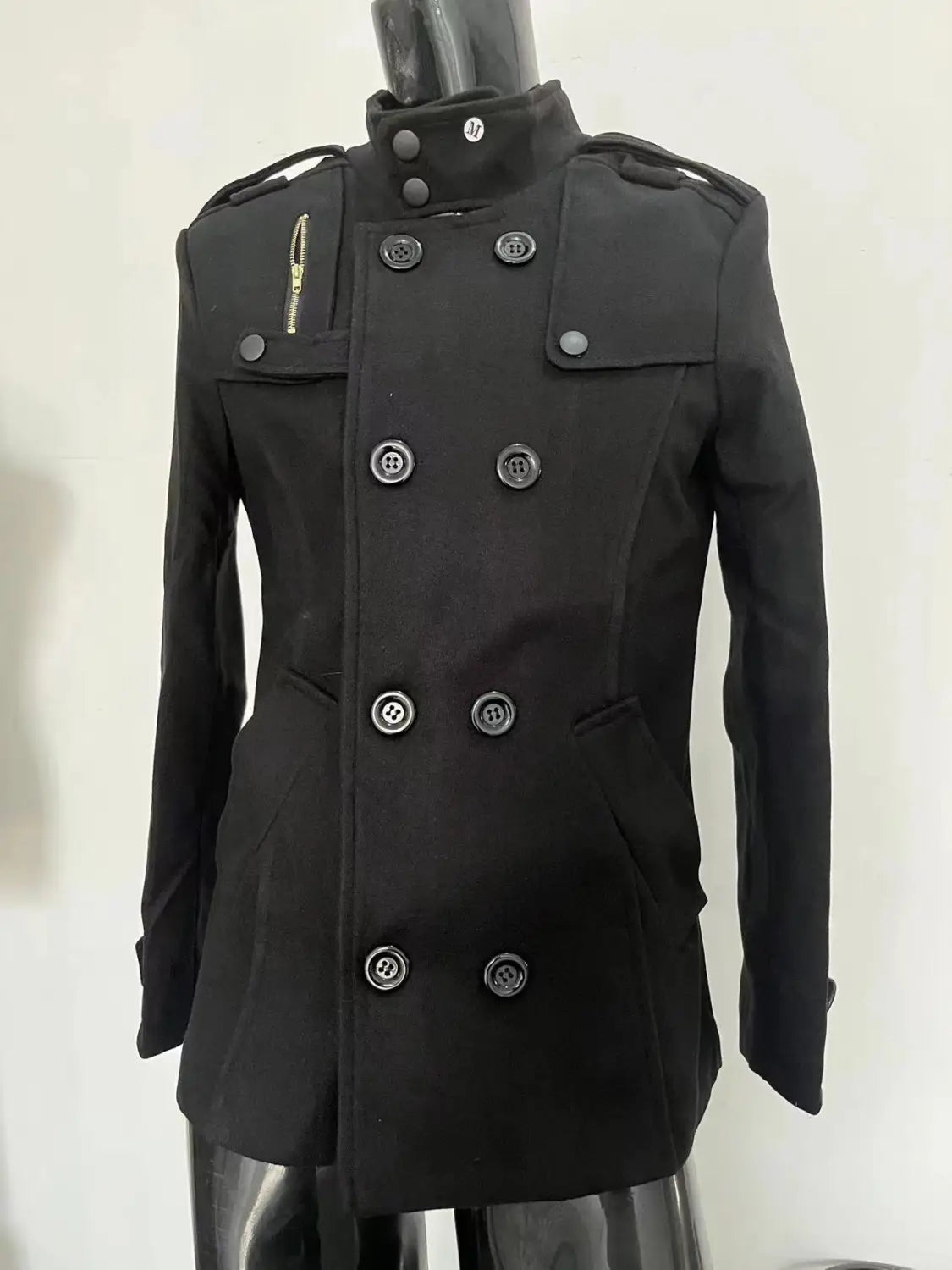 black double breasted warm woolen coat for men featuring silver toned buttons and epaulets designed as a woolen jacket for cold weather use