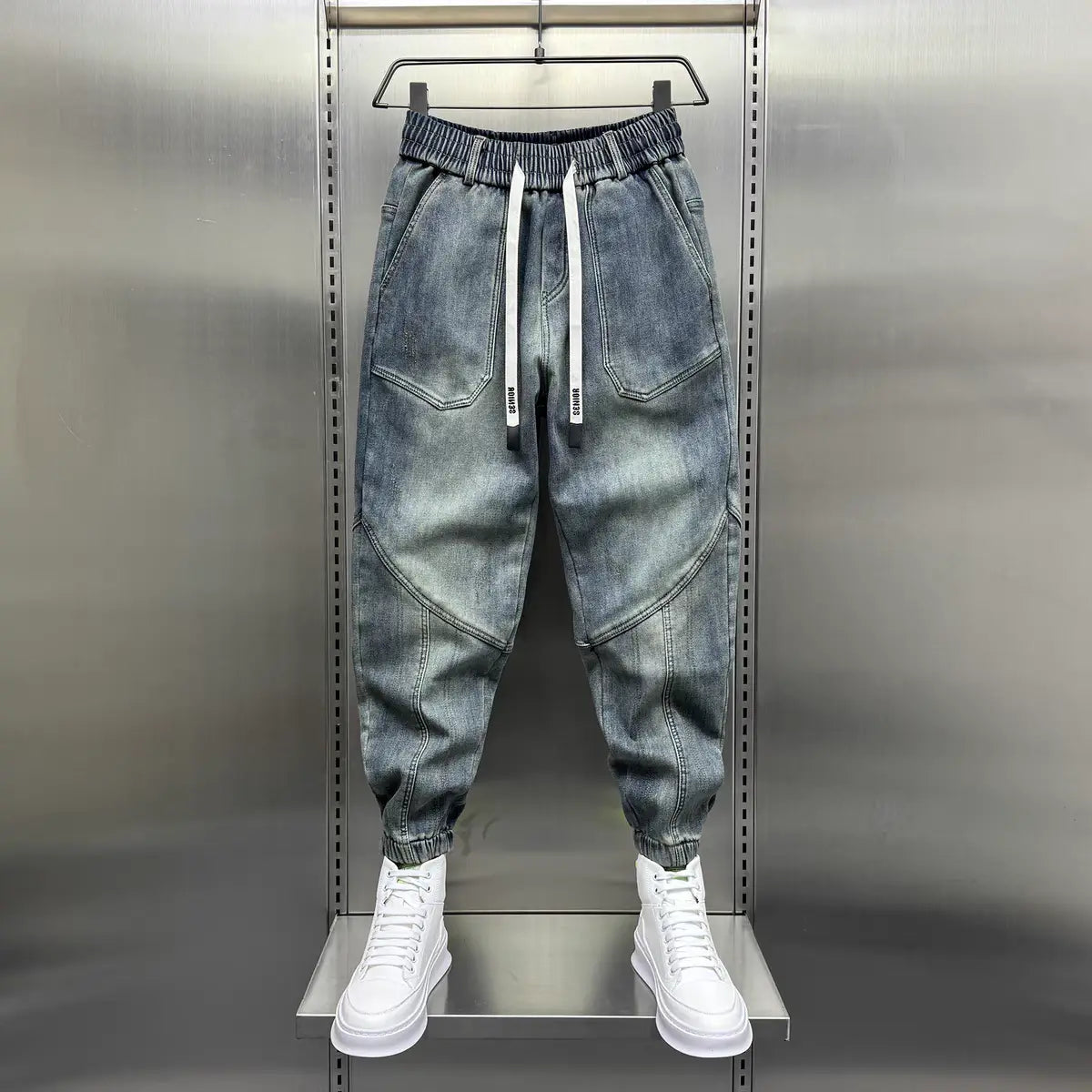 Graue Denim-Jogger mit weißen Kordeln und elastischen Bündchen im Stil von lockeren Herren-Haremhosen aus Denim
