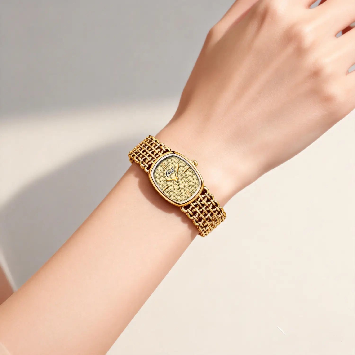 Gold-toned mesh bracelet watch with a rectangular face and intricate diamond-like pattern on the dial in an elegant women quartz timepiece.