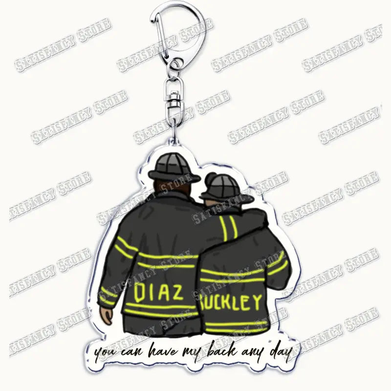 clear acrylic 9-1-1 tv show keychain featuring two firefighters in black jackets with yellow reflective stripes and helmets labeled diaz and huckley with the phrase you can have my back any day, designed as a firefighter gift.