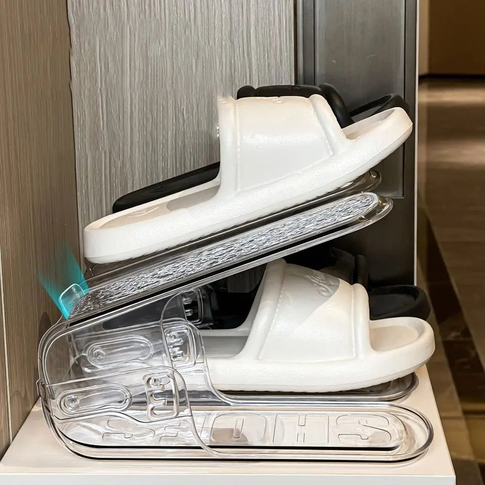 White plastic slide sandals displayed on a clear transparent plastic shoe slots organizer with double layer shoe rack design.