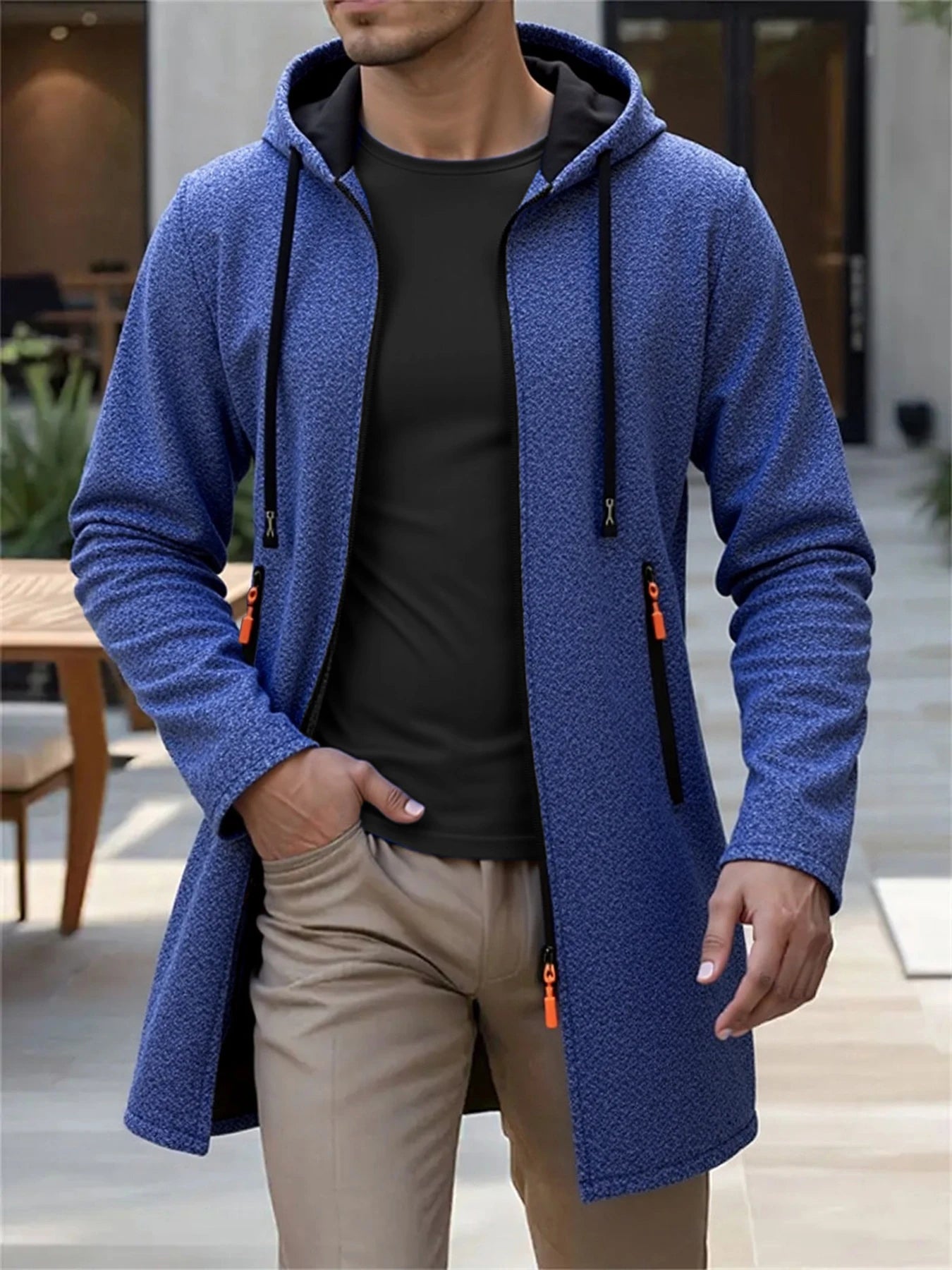 Men’s fleece lined knit hooded jacket in blue textured fabric with black inner lining and orange zipper pulls.
