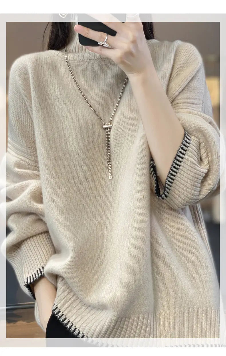 Beige pure wool oversized turtleneck sweater for women with ribbed cuffs and hem featuring a subtle black and white striped trim.