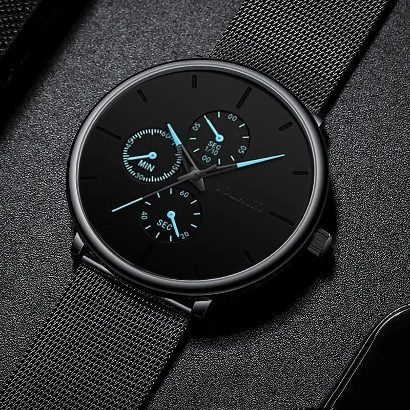 Montre à quartz à maille noire ultrafine pour hommes, avec un cadran chronographe noir et des aiguilles bleu lumineux, ainsi qu’une sangle en maille.