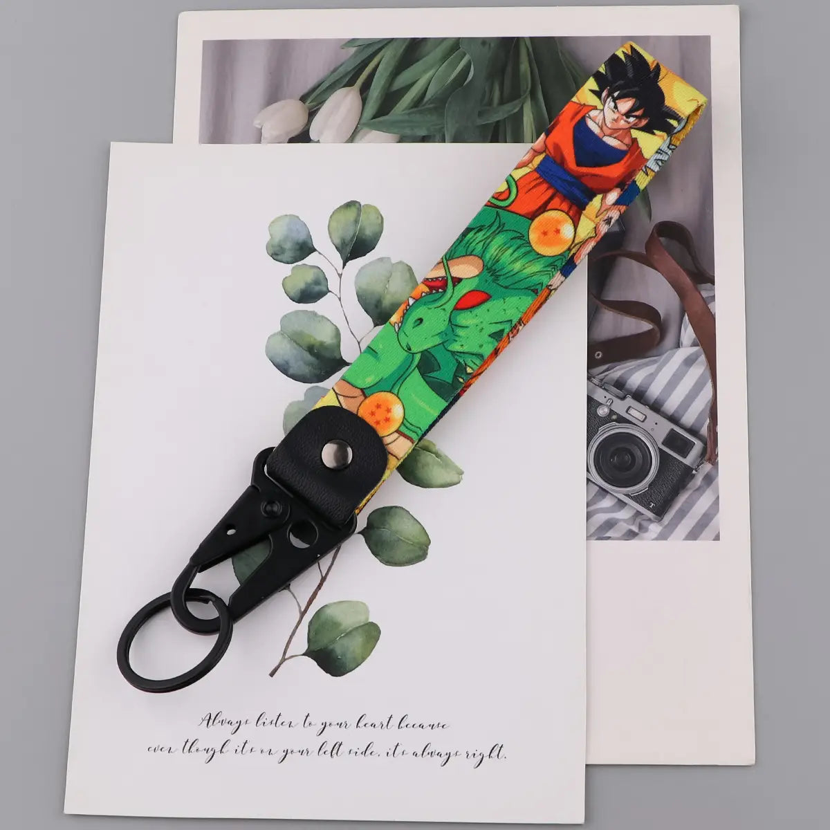 a vibrant dragon ball z goku and vegeta fabric lanyard keychain set featuring a colorful print of goku and shenron with black metal hardware