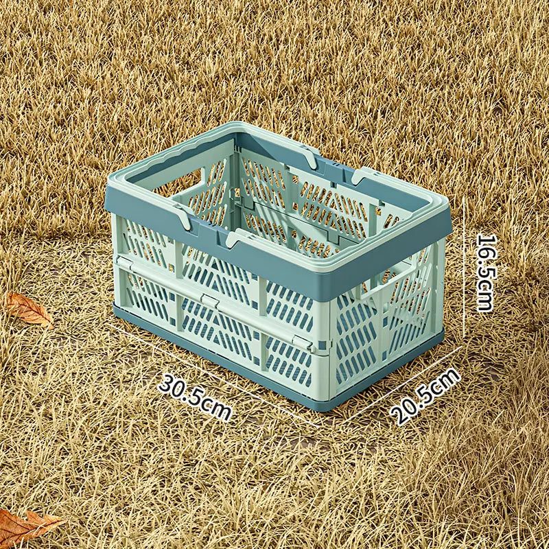 A light blue foldable plastic storage basket with a perforated design and reinforced handles for easy collapsing and storage.