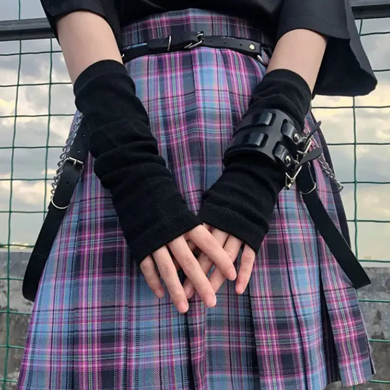 black fingerless gloves with studded leather cuff on the right hand shown as striped knit fingerless arm warmers
