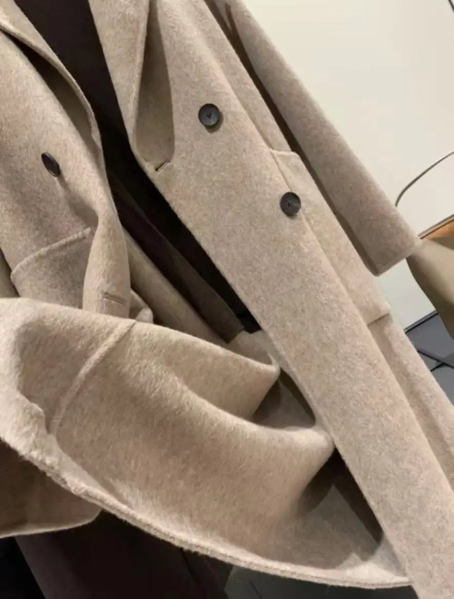 Women wool blend double breasted coat beige with dark buttons made of wool blend fabric.
