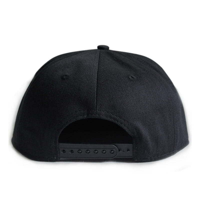 Black sugar skull rivet snapback baseball cap with a flat brim and adjustable strap shown from the back side.