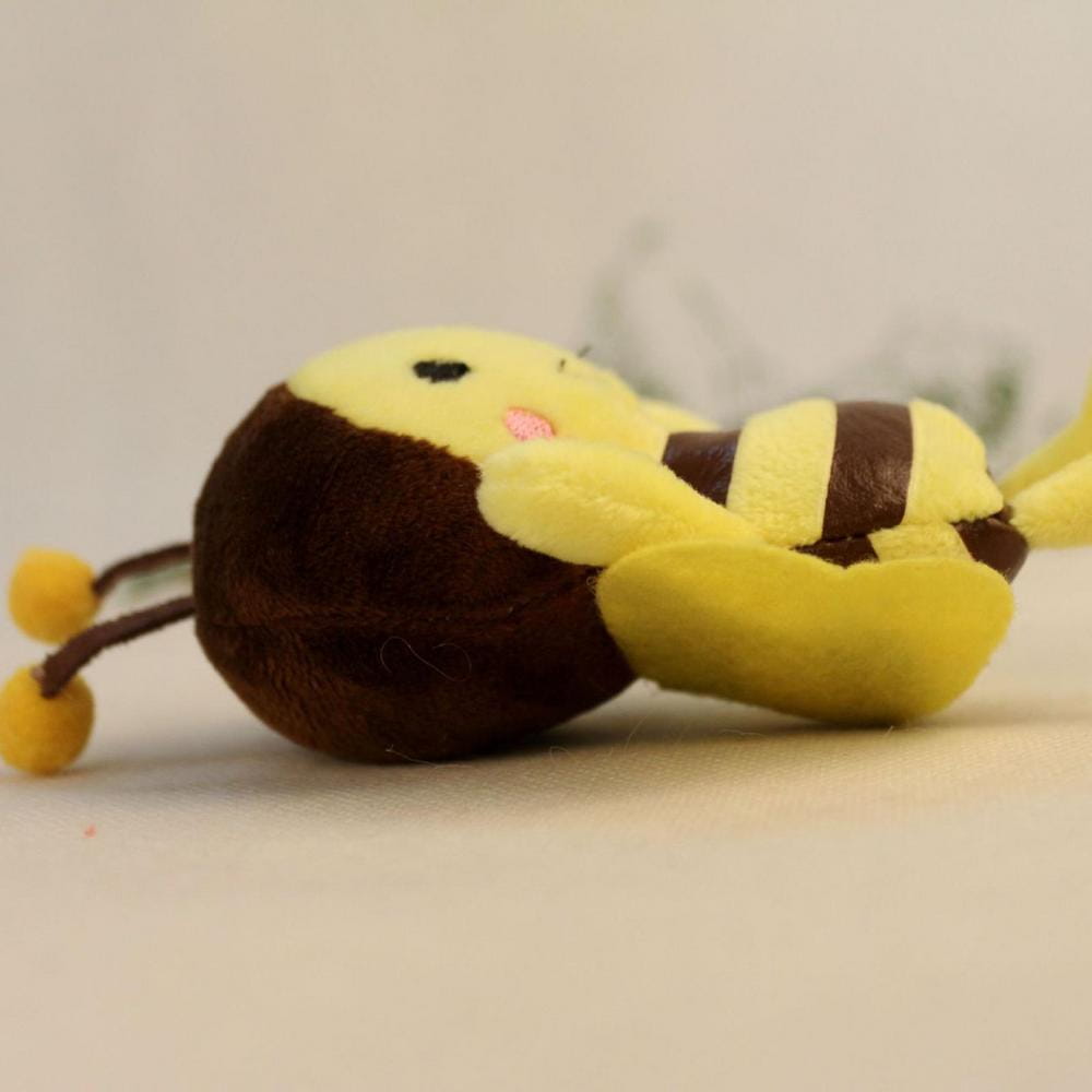 a bee stuffed animal plush toy featuring a yellow and brown striped body made of soft fabric with small antennae ending in yellow balls.