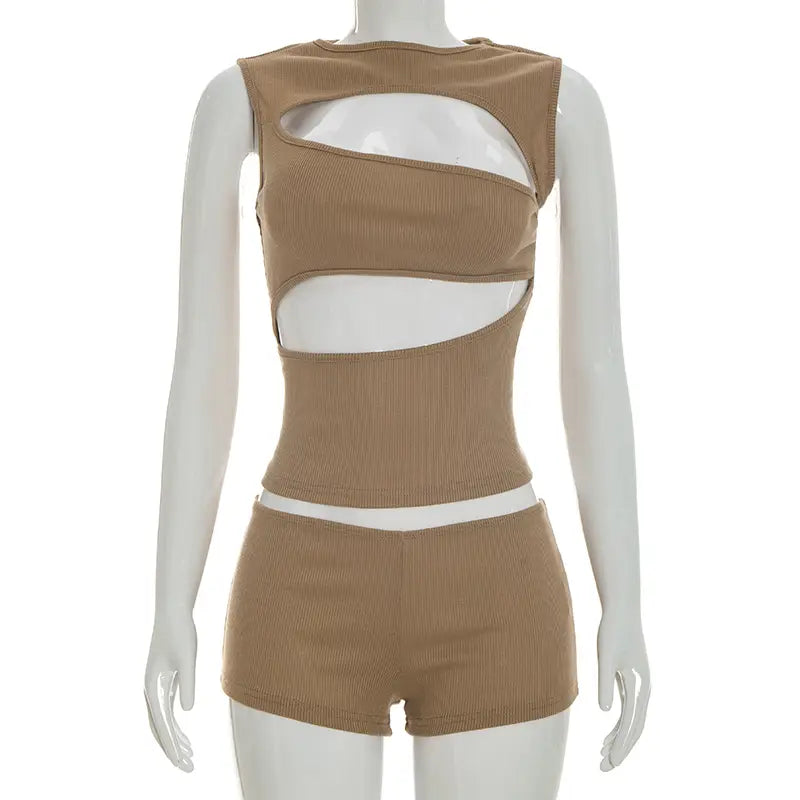 Tan ribbed knit two-piece set featuring asymmetrical cutouts and white trim, including a tank top and shorts.
