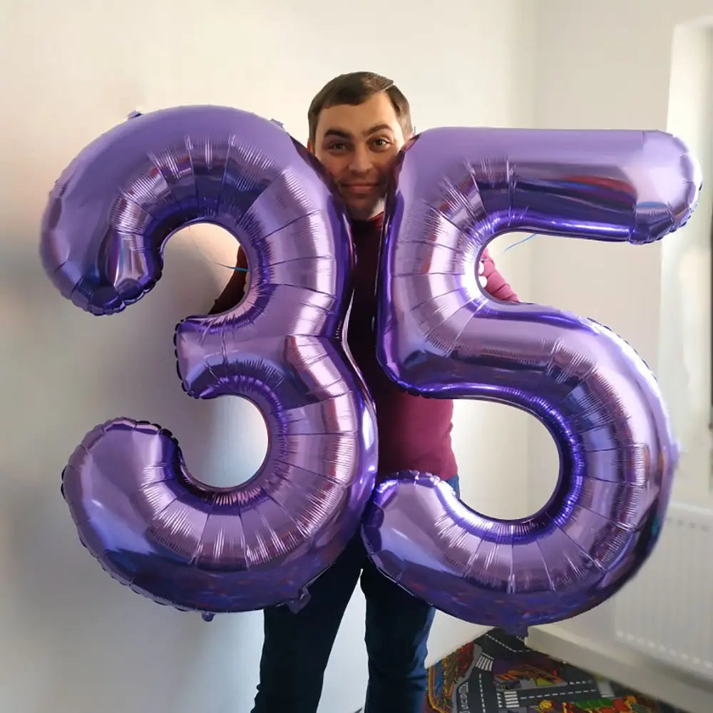 Shiny purple metallic foil balloon shaped like the number 35 for birthday party decoration measuring 32 inches.