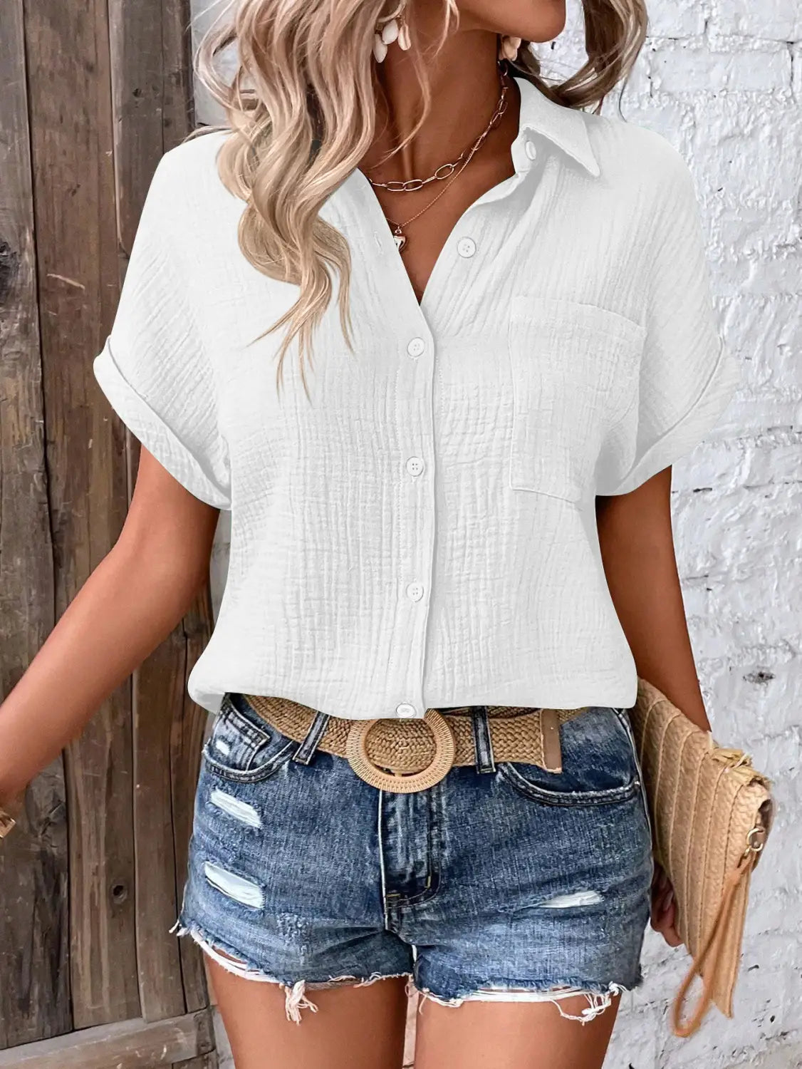 Women cotton short sleeve button up shirt in white featuring a textured crinkled fabric finish.