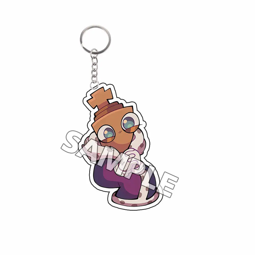 Llavero acrílico marrón adorable como producto terminado, con un personaje tipo TADC de caricatura de grandes ojos, que lleva un atuendo morado y sostiene guantes blancos.
