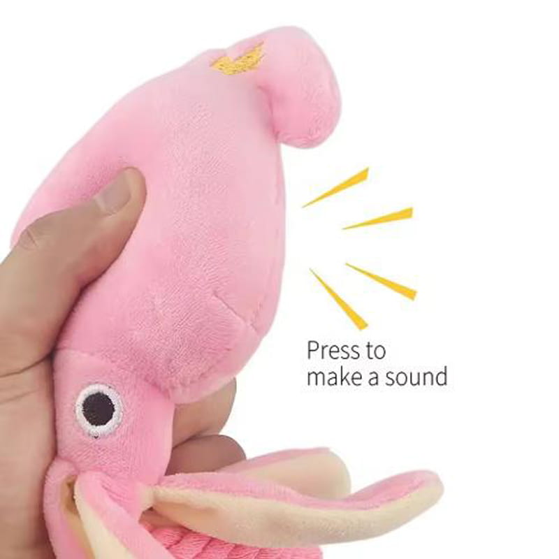 pink plush squid chew toy with soft fuzzy texture and embroidered black and white eyes designed as a chew toy for dogs
