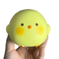 A soft pale yellow giant chicken squishy toy with orange feet and beak for stress relief and sensory calming