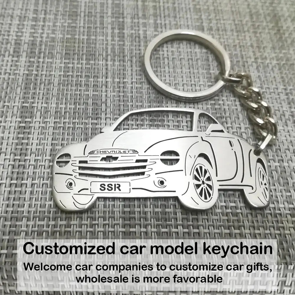 Customized car model metal keychain featuring a silver metallic keychain shaped like a Chevrolet SSR with detailed outline and engraved branding.