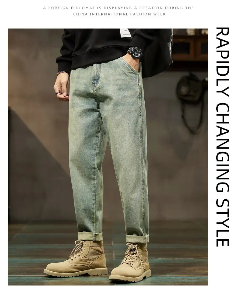 Men loose denim harem jeans in light-wash denim with a relaxed straight-leg cut and rolled cuffs.