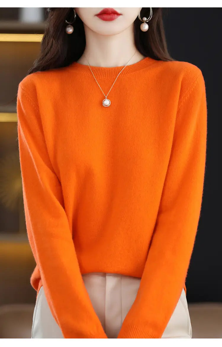 Vibrant orange pure wool cashmere o-neck pullover sweater with long sleeves and ribbed cuffs.