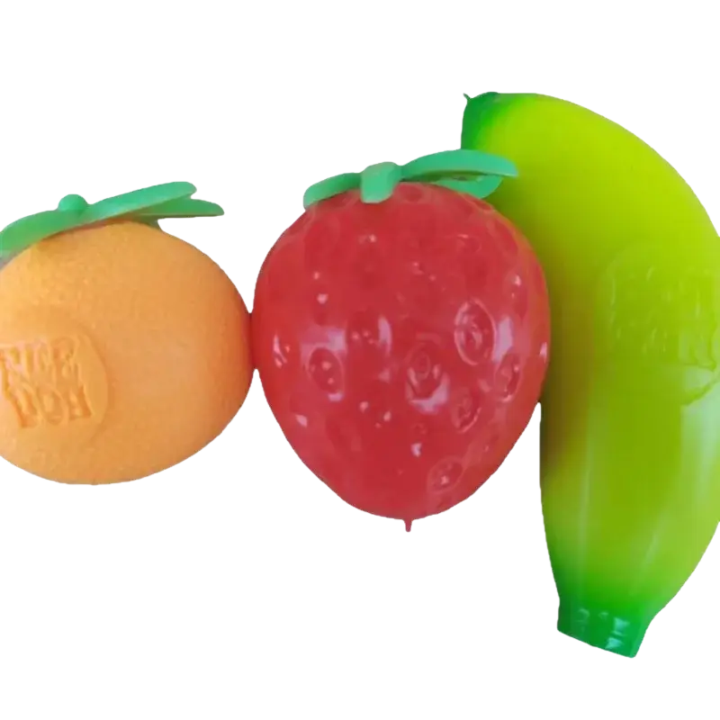 Bright orange, red strawberry, and green banana-shaped playdough containers with molded fruit details front view