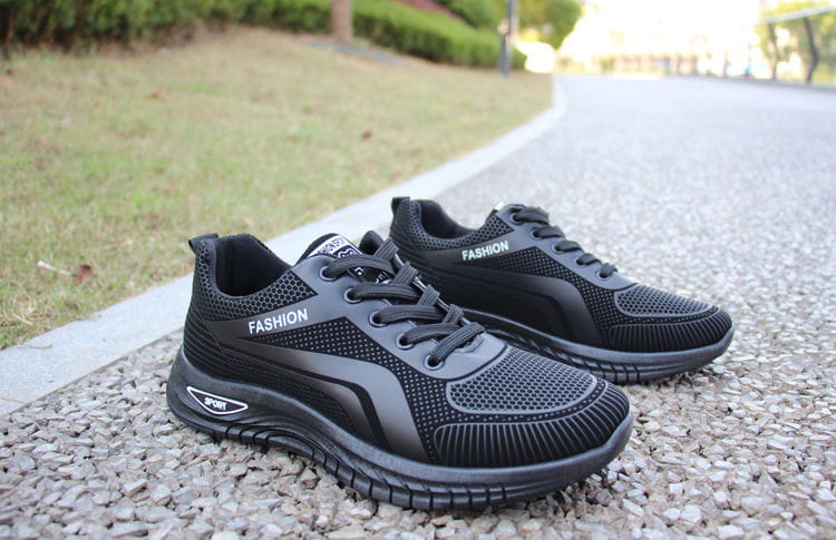 Men breathable athletic sneakers running shoes in black mesh with a sleek modern design and fashion branding on the side