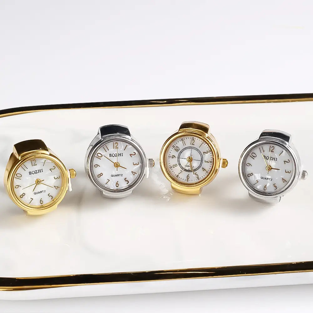 Four bozhi brand ring watch quartz finger jewelry with white faces black numerals and gold or silver-toned cases suitable as a unisex gift.