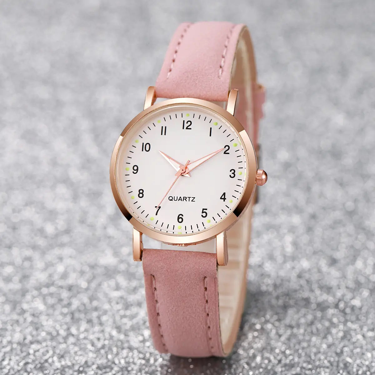 A delicate arabic dial rose gold leather women watch featuring a white dial and pink leather strap.