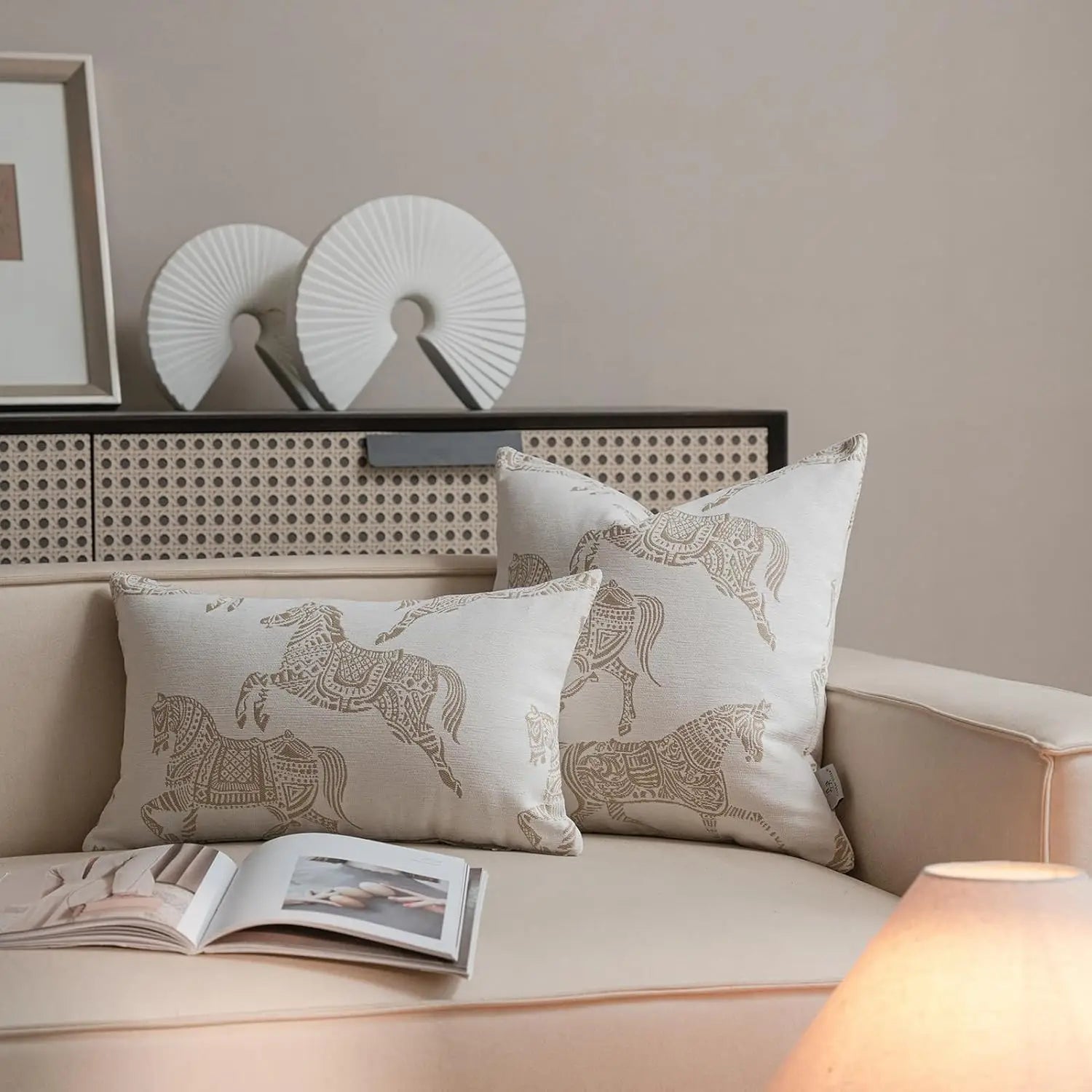housse de coussin de luxe couleur lin sec crème présentant des motifs de chevaux métalliques dorés complexes en tissu jacquard.