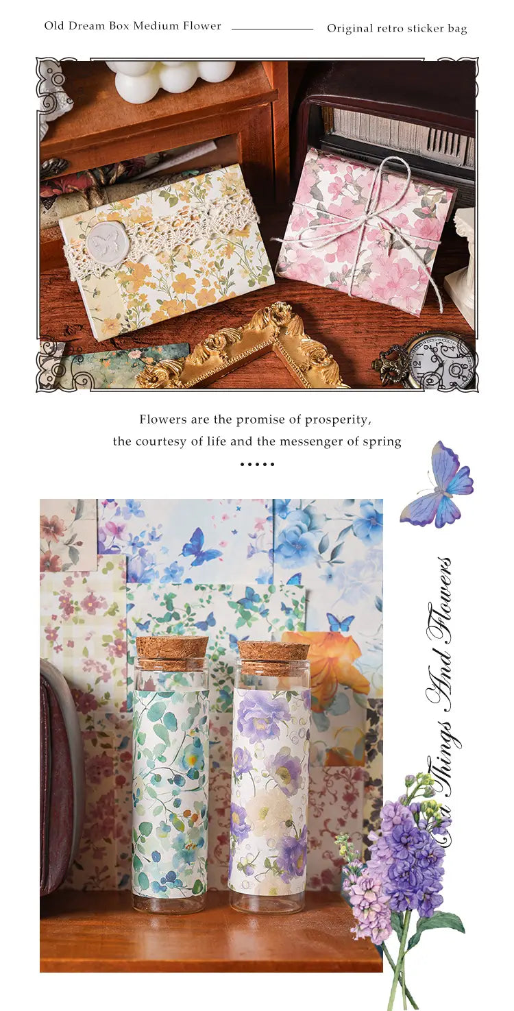 Two clear glass bottles with cork stoppers wrapped in delicate vintage scrapbooking paper featuring blue and purple floral patterns for journaling supplies.