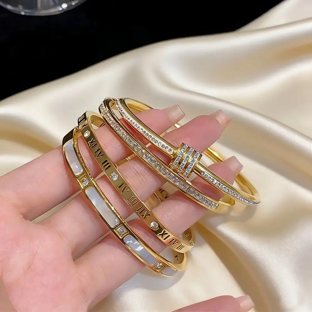 Stainless steel gold roman numeral bangle bracelet for women featuring a sleek metallic finish with embedded diamonds.