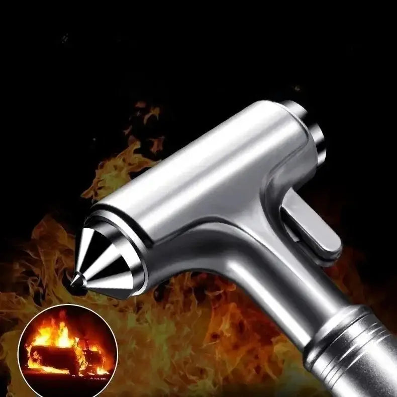 Silver metallic car safety hammer with pointed tip and textured grip for emergency use and seat belt cutting.