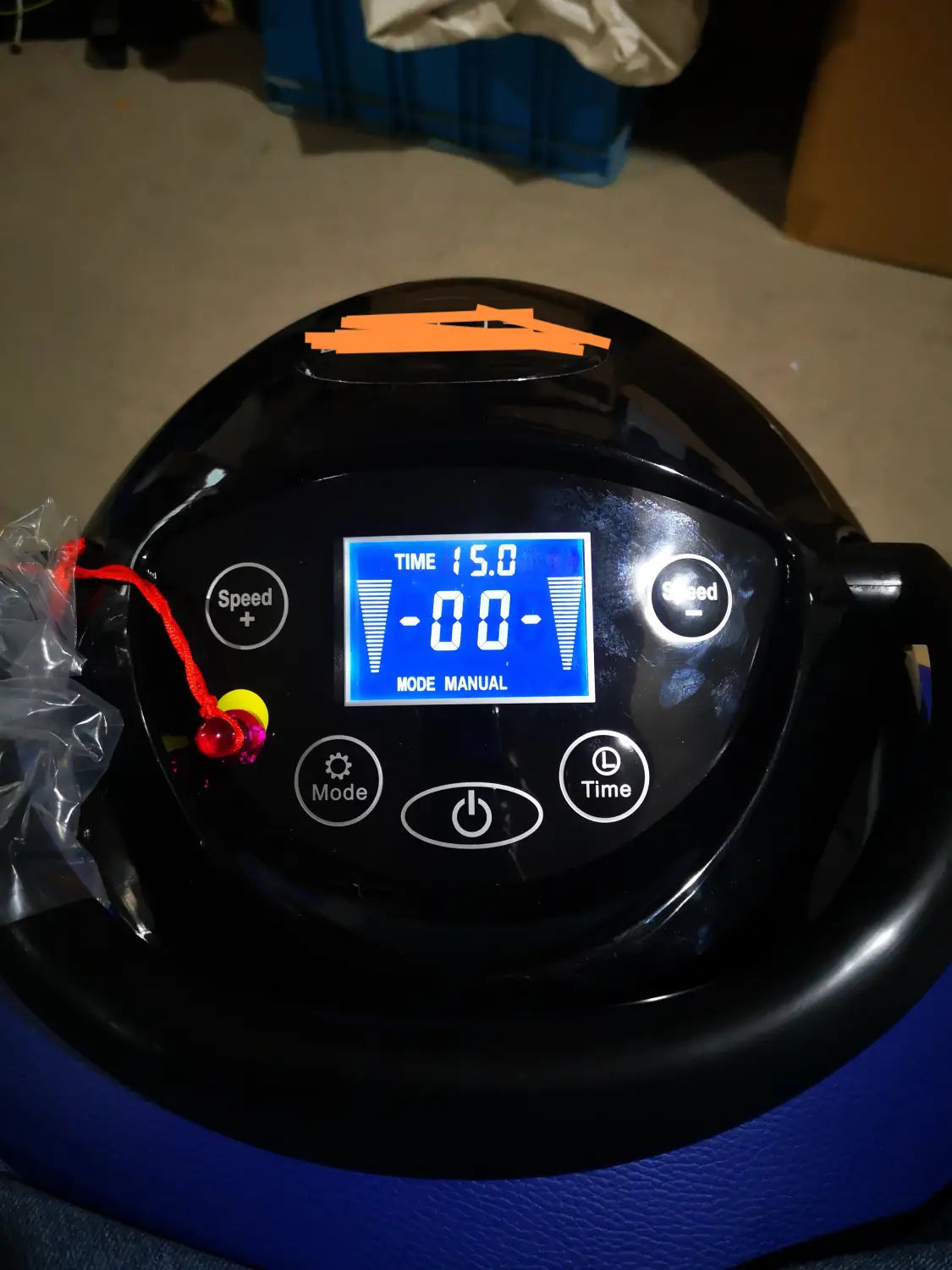 Black and blue inflatable air pump with a digital display showing time and mode settings for horse riding exercise machine fitness equipment.