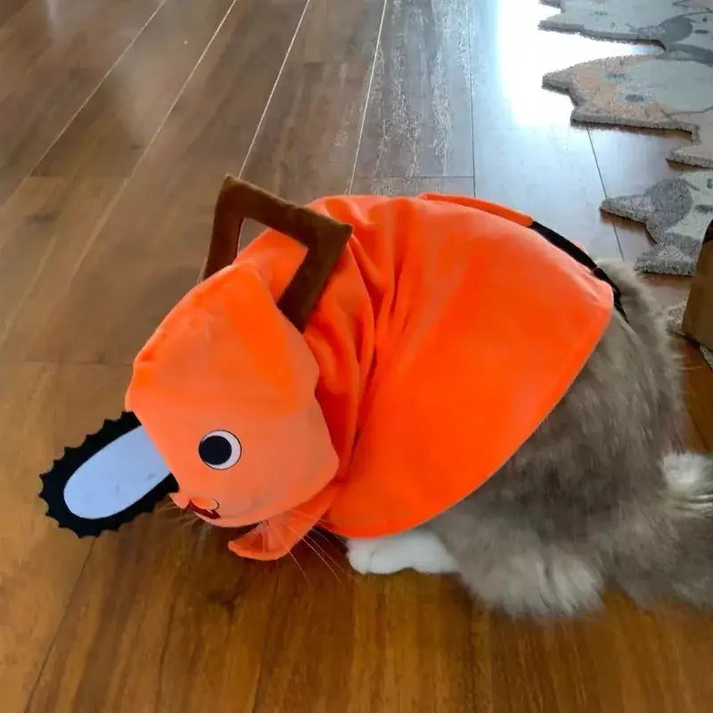 猫・犬用のファッショナブルなペット服として設計された、茶色いハンドルと黒いチェーンのディテールを備えたオレンジのぬいぐるみ風ポチタのペット服チェーンソーコスチューム。