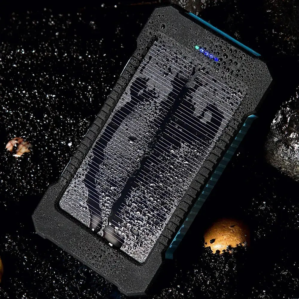 black rugged 20000mah solar power bank with textured surface and blue led indicator lights featuring a dc5v dual usb solar panel for portable charging.