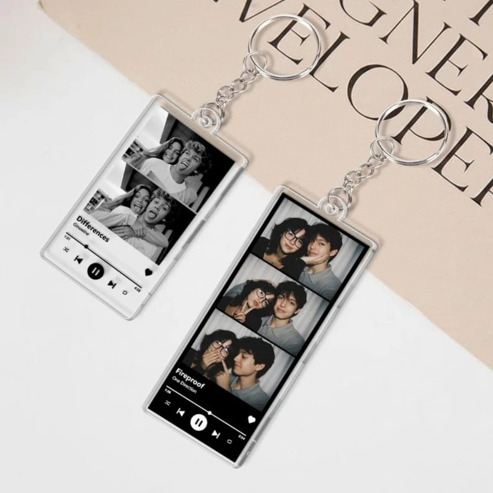Clear rectangular acrylic custom Spotify music player keychain featuring black and white photo collages with song titles and playback controls printed on them.