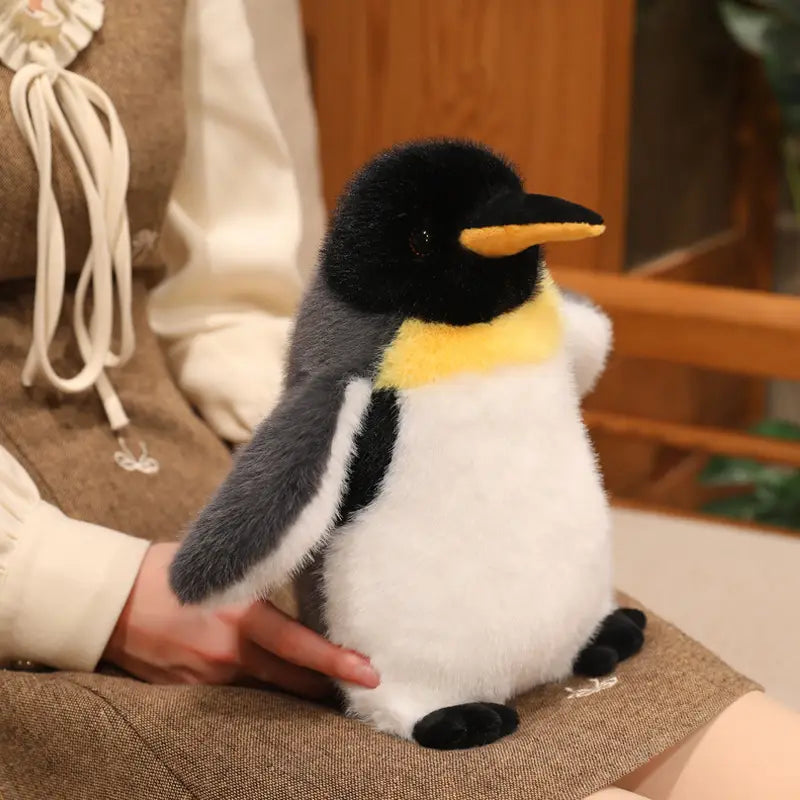 A plush penguin stuffed animal soft toy pair featuring a black head, yellow beak and chest band, gray wings, white belly, and black feet.