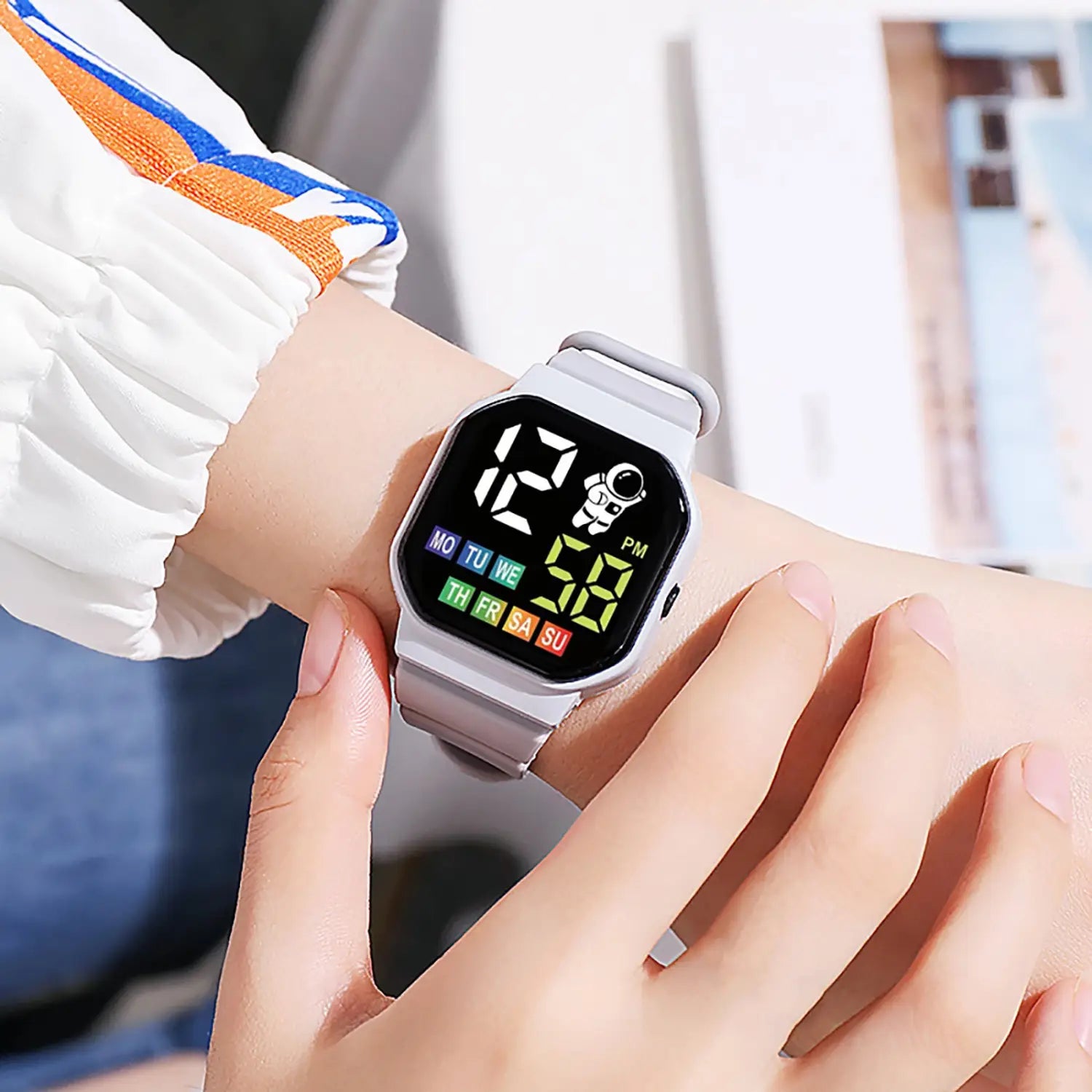 Kids astronaut led digital watch white with a gray square face, colorful led display showing time and day of the week, and an astronaut graphic.