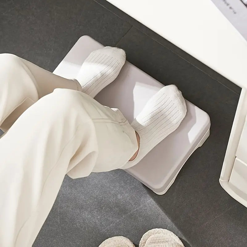ergonomic under desk white plastic footrest with rounded edges and a smooth minimalist design