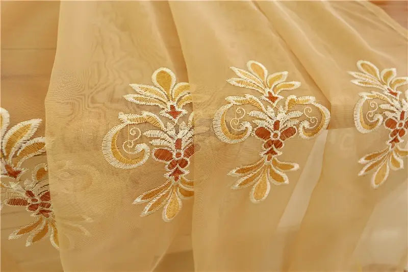 beige sheer embroidered living room curtains with intricate gold and white floral threadwork designed for french window use