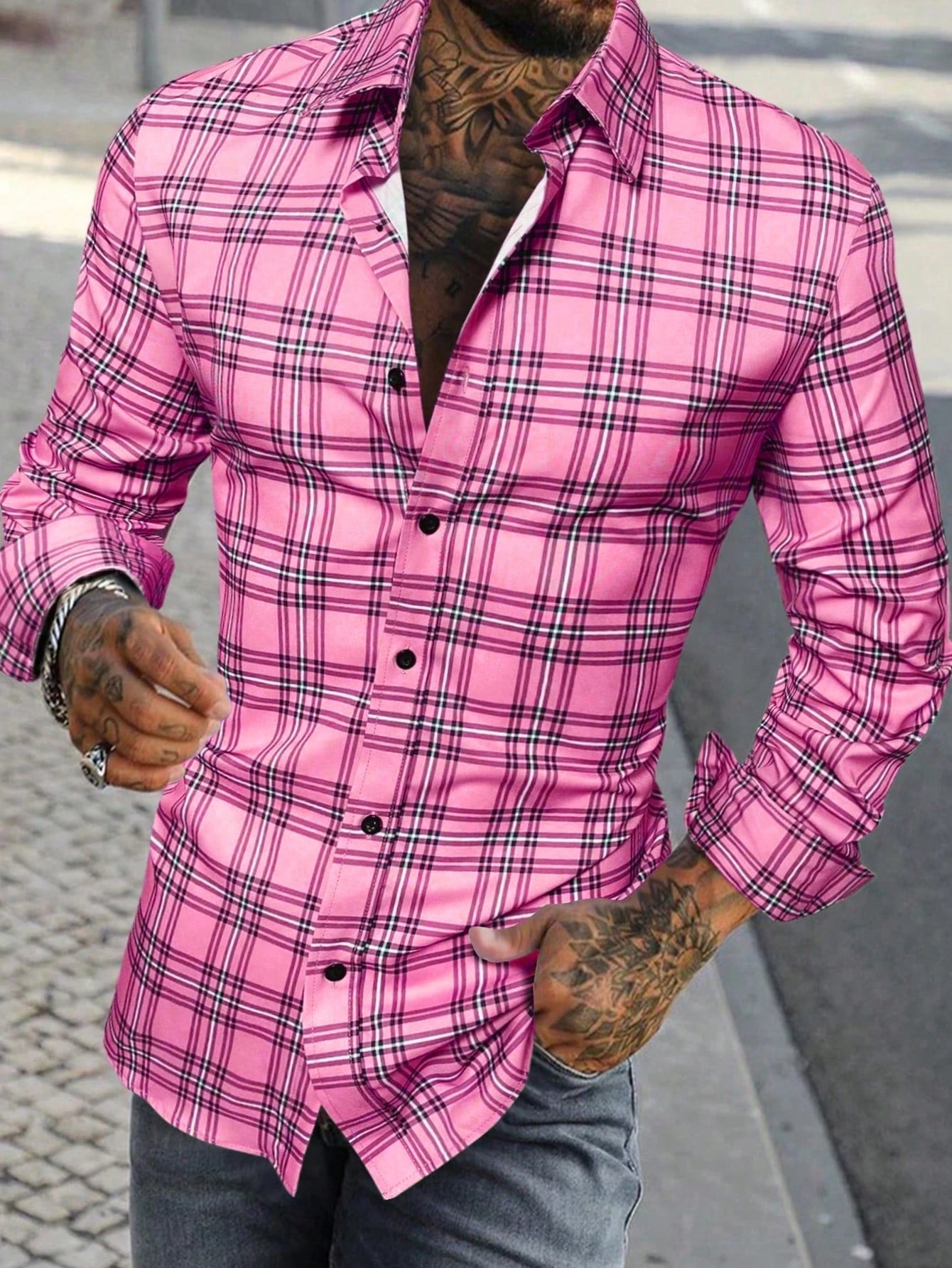 A vibrant pink plaid men’s long sleeve casual button up shirt with black and white intersecting lines, classic collar, and button-down front.